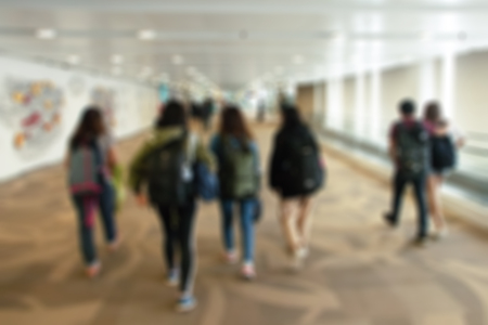 Blurred background. Blurred people walking through a pathway for travel.