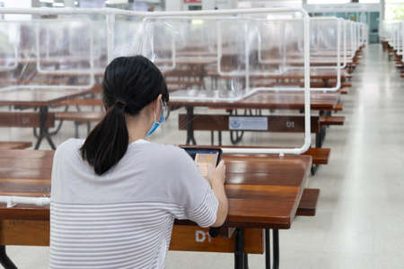 New normal lifestyle in Thailand by using plastic sheets divided public space In the school cafeteria to prevent the spread of covid-19 according social distancing policyの写真素材