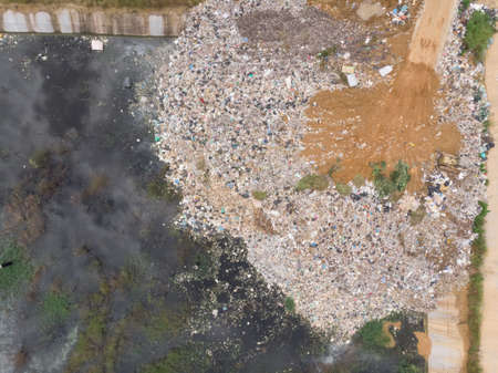 Aerial shot of drone Of plastic waste That were left piled up near the water source Causing environmental pollution problemsの写真素材
