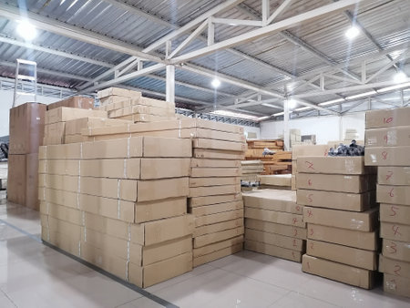 Warehouses that store goods which are packed in cardboard boxes and stack them together ready for deliveryの写真素材