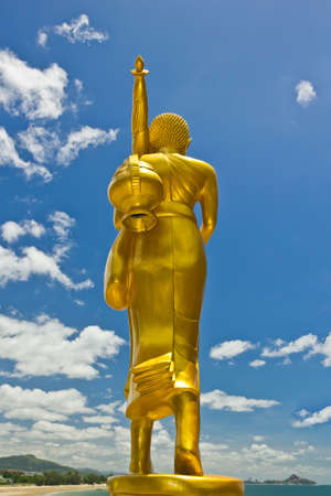 Golden Buddha statue in a Buddhist temple and blue skyの写真素材