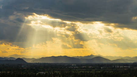 Sun rays on blue sky over the mountainの写真素材