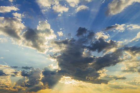 Sun rays on blue sky over the mountainの写真素材