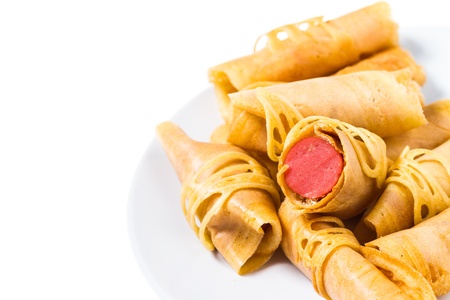 Isolated rolled of Tokyo Pancake Sausage on diskの写真素材