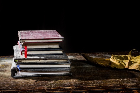 Pile of old notebooks on wooden tableの写真素材
