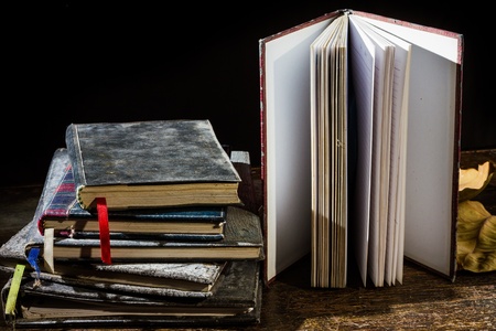 Pile of old notebooks on wooden table