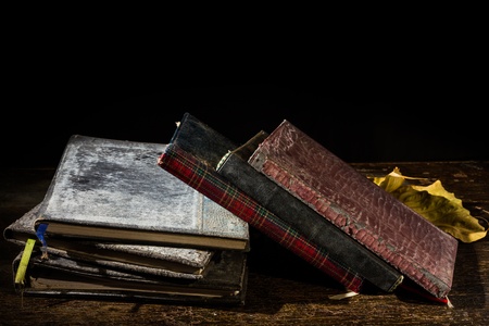 Pile of old notebooks on wooden tableの写真素材