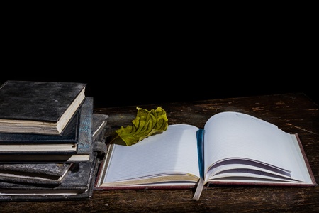 Pile of old notebooks on wooden tableの写真素材