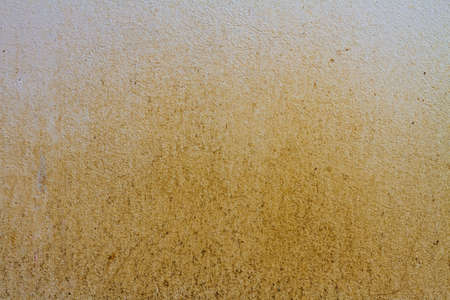 Yellow dirty concrete wall background textureの写真素材