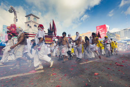 PHUKET - OCT 11  Devotees of a Chinese Taoist shrine carry a palanquin housing a Chinese God idol in a street procession to mark the Phuket Vegetarian Festival on Oct 11, 2013 in Phuket, Thailand のeditorial素材