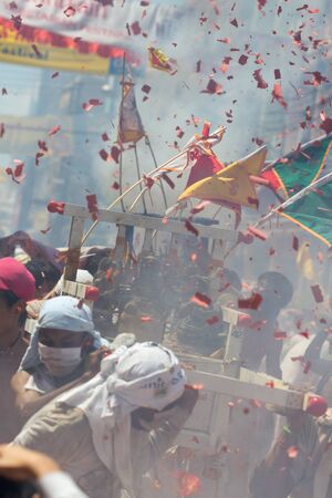 PHUKET - OCT 11  Devotees of a Chinese Taoist shrine carry a palanquin housing a Chinese God idol in a street procession to mark the Phuket Vegetarian Festival on Oct 11, 2013 in Phuket, Thailand のeditorial素材