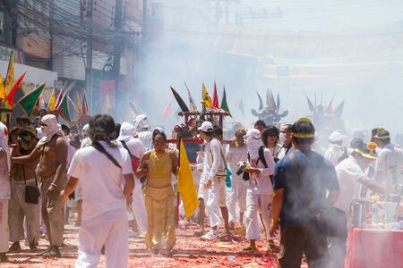 PHUKET - OCT 11  Devotees of a Chinese Taoist shrine carry a palanquin housing a Chinese God idol in a street procession to mark the Phuket Vegetarian Festival on Oct 11, 2013 in Phuket, Thailand のeditorial素材