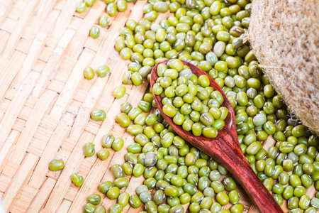 Green beans or mung beans on spoon and wooden backgroundの写真素材