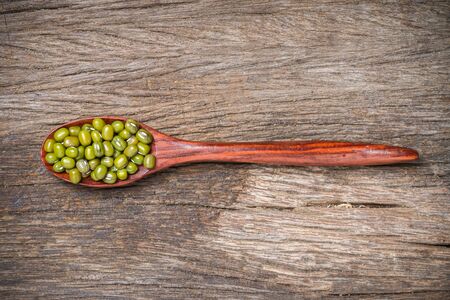 Green beans or mung beans on spoon and wooden backgroundの写真素材