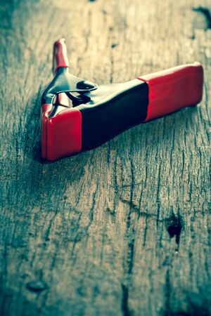 Small  spring clamp on wooden backgroundの写真素材