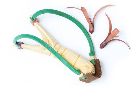 Isolated of wooden catapult slingshot with seed plant on white backgroundの写真素材
