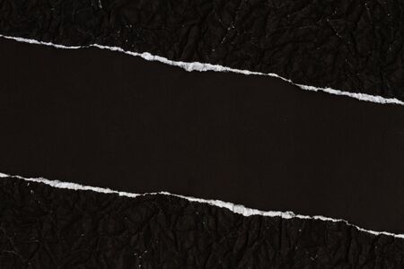 Ripped crumpled black paper with spaceの写真素材
