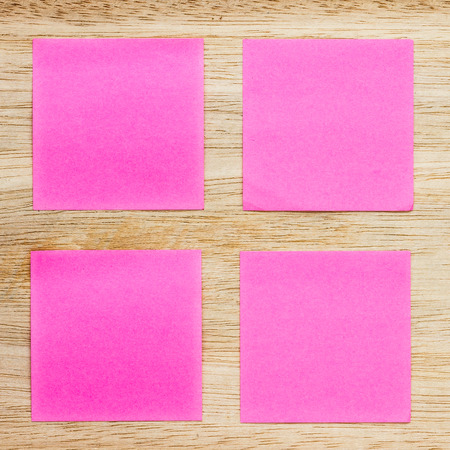 Colored sticker paper note on wooden board with place for textの写真素材