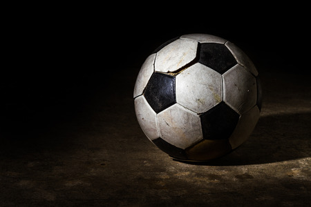 Old Soccer ball on dark backgroundの写真素材