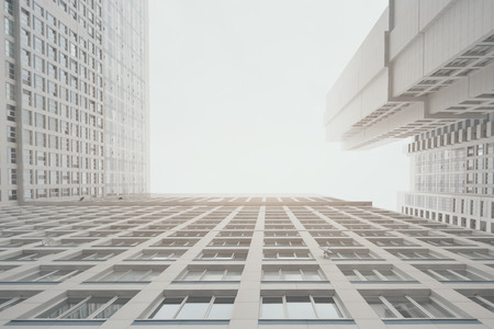 Contemporary white and grey residential skyscraper apartment building with right angle between...