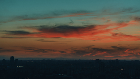 Dramatic red scenery of the city silhouette at sunsetの写真素材