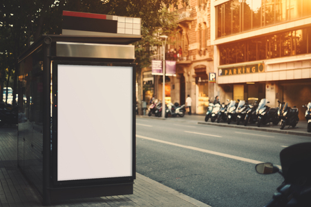 City bus stop with empty mock up banner for your advertising, blank billboard with copy space area for your text message or promotional content, public information board next to roadの写真素材