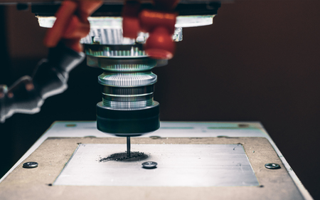 Close-up view of CNC milling machine cutting work piece of aluminum with high rotation speed in dark settings with copy space for young advertising text message or promotional contentの写真素材