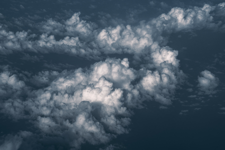 View from above of beautiful maritime cumulus clouds illuminated by morning sun with Indian ocean belowの写真素材