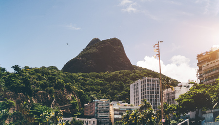 View of the Two Brothers mountain located in beach zone of Rio de Janeiro in Brazil between Leblon and Sao Conrado districts, surrounded by residential houses and hotels; sunny summer dayの写真素材