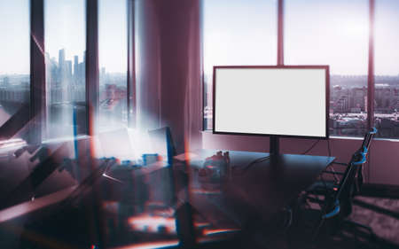 True tilt-shift shooting of abstract modern office meeting room with white blank mock-up of screen for presentationsの写真素材