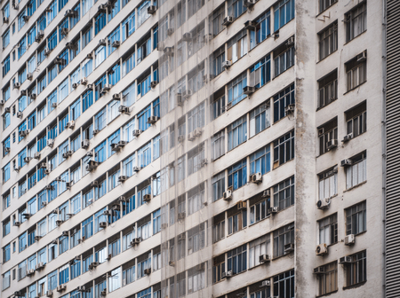 Side view of a regular beige high-rise apartment building in Rio de Janeiro, Brazil without balconies,の写真素材