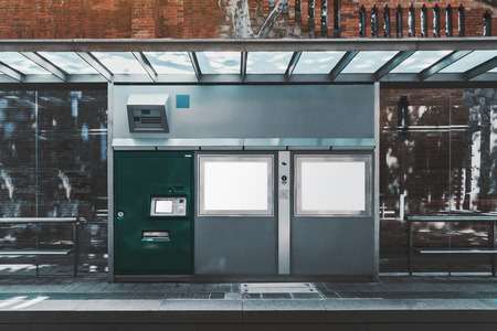 A modern public transport stop with the mock-up of an urban electronic counter: templates of two rectangular LCD screens for map, ad, and information, payment terminal for buy tickets, SOS intercomの写真素材
