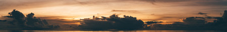A panoramic view of a stunning dramatic sunset over the ocean, evening on the Maldives, tropical...