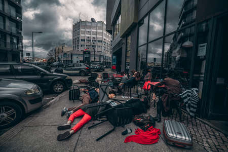 Lisbon, Portugal - April 8, 2022: actionists with their children staged a flash mob action in front of the Russian embassy, depicting refugees killed during a bombing of Kramatorsk station in Ukraineのeditorial素材