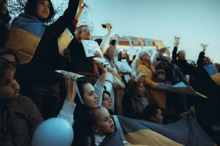 Lisbon, Portugal - April 20, 2022: a night protest action dedicated to saving the Ukrainian city of Mariupol which was almost totally destroyed by Russia; people shine their cell phone flashlights upのeditorial素材