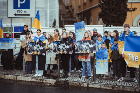 Lisbon, Portugal - February 24, 2023: In this anti-war demo marking the one-year anniversary of the Ukraine conflict, adults and children hold banners and signs, united in their call for peace.のeditorial素材