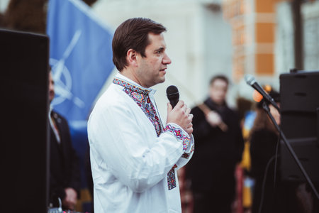 Lisbon, Portugal - February 24, 2023: Ricardo Baptista Leite, a Portuguese Deputy, wearing traditional Ukrainian embroidery, speaks at the one-year anniversary of the war in Ukraine demonstrationのeditorial素材