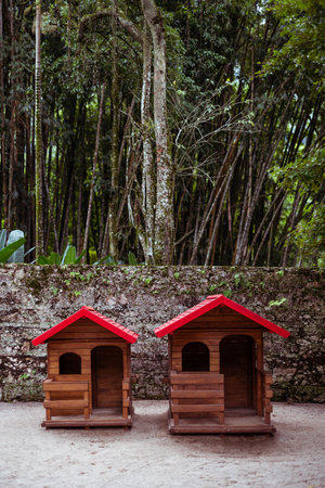 Inviting children's wooden playhouses set in Rio's vibrant tropical playground, a slice of innocence and adventure amid the urban sprawl; a vertical wide-angle shotの写真素材
