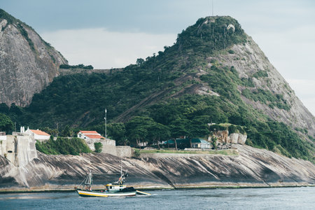 A telephoto shot of a scenic coastal view of a traditional fishing boat in Rio de Janeiro, Brazil...