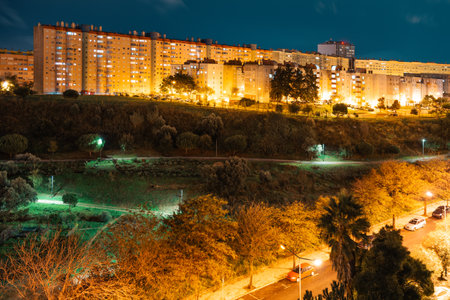 A nighttime long exposure cityscape of a Lisbon residential area showcasing apartment buildings...