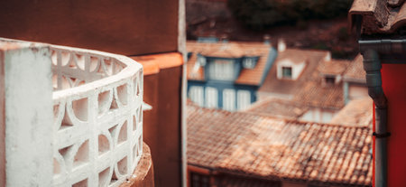 Scenic rooftop panorama of traditional Mediterranean houses with terracotta tiles, blurred background, and architectural detail in the foreground, offering ample copy space; shallow depth of fieldの写真素材
