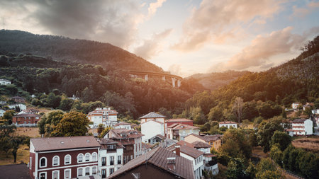 Sunset panorama of Salas, Asturias, along Camino de Santiago Primitivo: warm light on red roof...