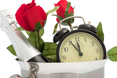 Sparkling wine pail with roses and alarm clockの写真素材