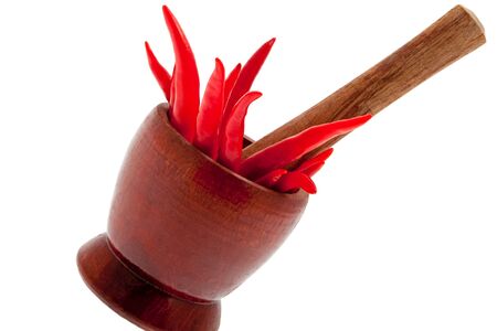 Red chillis with mortar and white backgroundの写真素材