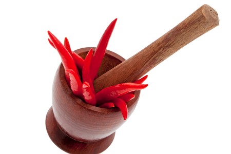 Red chillis with mortar and white backgroundの写真素材