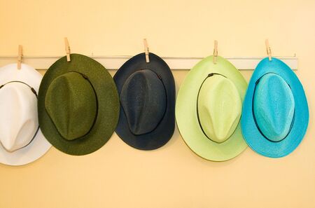 Colored straw hats on the wallの写真素材