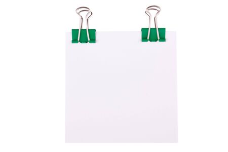 Green paperclip with note paper in front of white backgroundの写真素材
