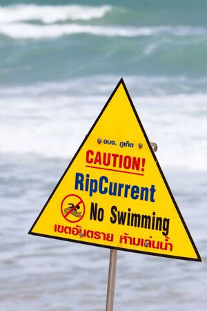 Warning sign with note on the beachの写真素材