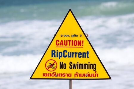 Warning sign with note on the beachの写真素材