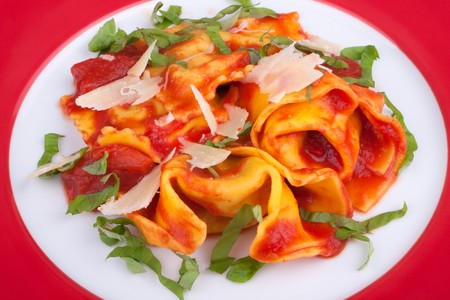 Tortellini with tomato sauce on the plateの写真素材